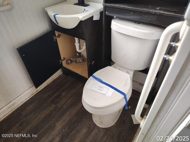 bathroom featuring toilet and wood finished floors