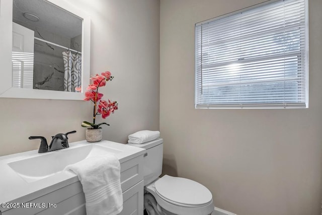 bathroom with vanity, toilet, and a shower with curtain