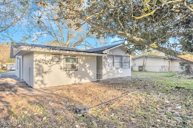 view of side of property featuring fence