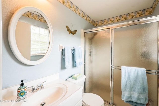 full bathroom featuring vanity, toilet, and a stall shower