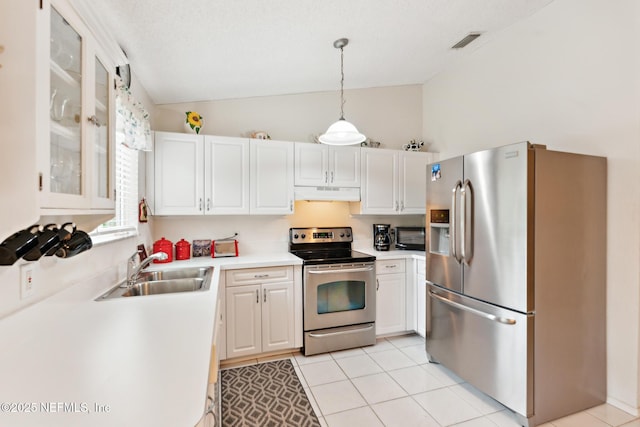 kitchen featuring visible vents, lofted ceiling, a sink, stainless steel appliances, and under cabinet range hood