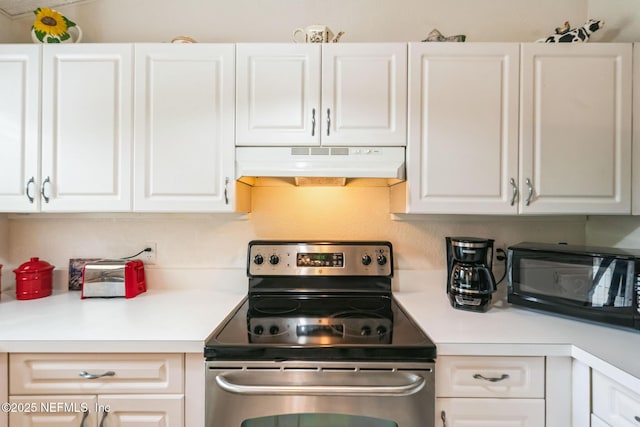 kitchen featuring under cabinet range hood, stainless steel electric stove, white cabinets, and black microwave