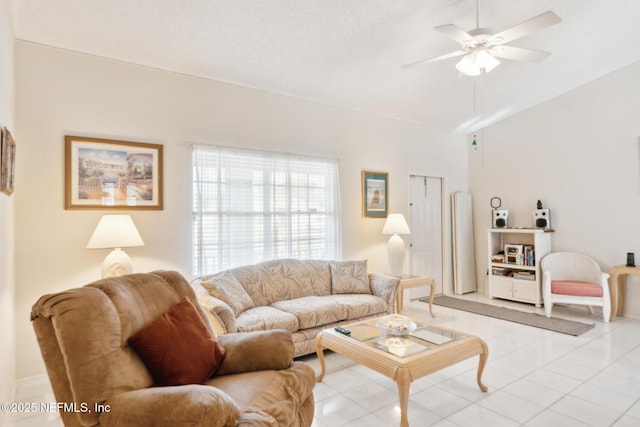 tiled living area featuring lofted ceiling and ceiling fan