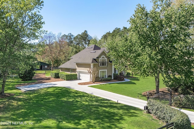 view of front of property featuring fence, a front yard, stucco siding, a garage, and driveway