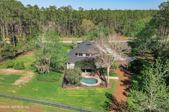 birds eye view of property with a view of trees