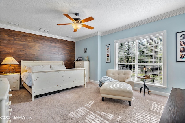 bedroom with carpet flooring, a textured ceiling, crown molding, and visible vents