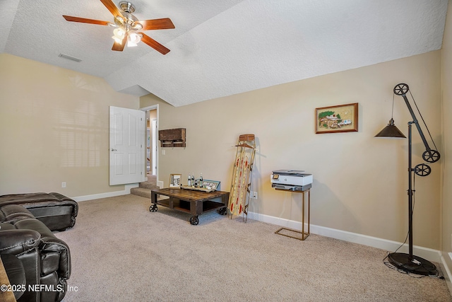 misc room with carpet, baseboards, visible vents, lofted ceiling, and a textured ceiling