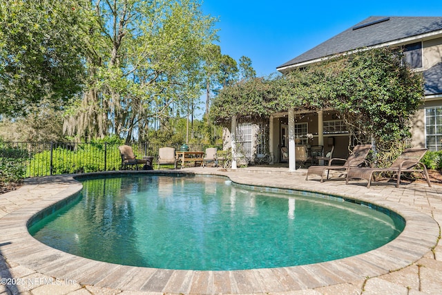 view of swimming pool featuring a fenced in pool, a patio, and fence