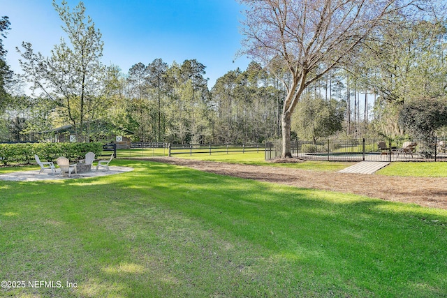 view of home's community with a patio area, a yard, and fence