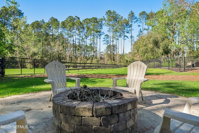 view of patio / terrace featuring fence and a fire pit