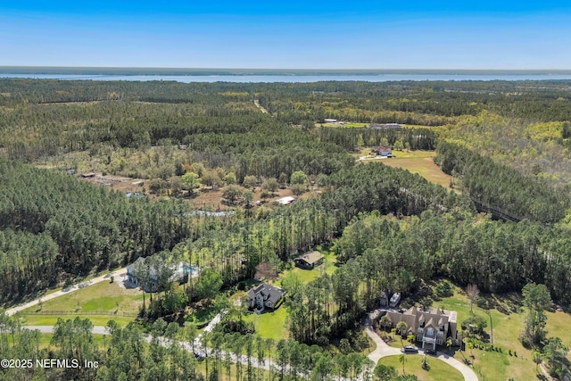 bird's eye view featuring a wooded view and a water view