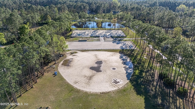 birds eye view of property featuring a wooded view and a water view