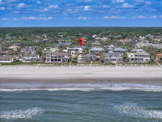 bird's eye view featuring a view of the beach, a water view, and a residential view