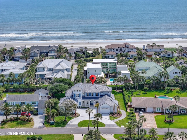 bird's eye view with a beach view, a water view, and a residential view