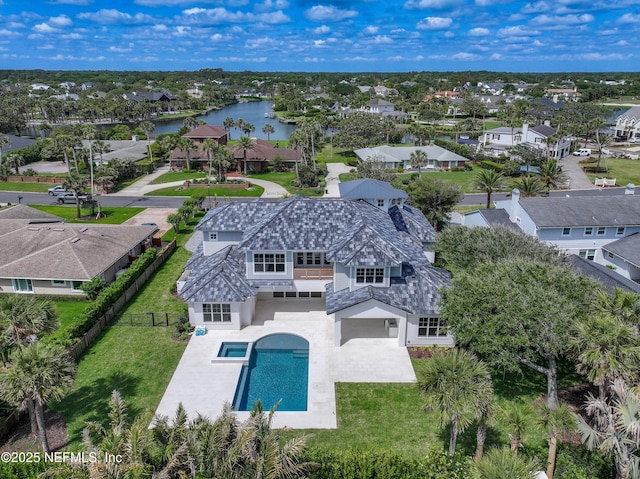 drone / aerial view with a water view and a residential view