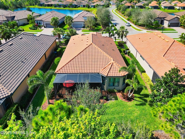 birds eye view of property with a residential view and a water view