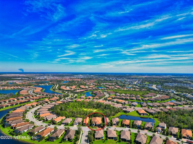 drone / aerial view with a residential view and a water view