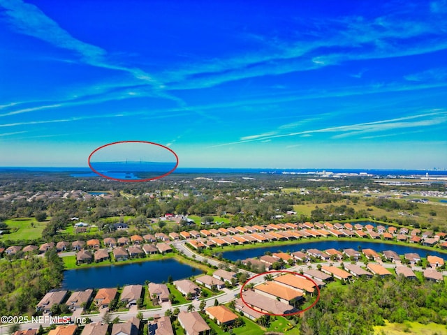 aerial view featuring a residential view and a water view