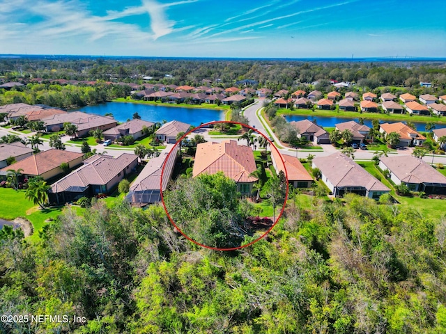 bird's eye view featuring a residential view and a water view