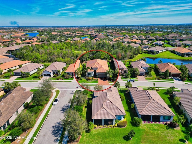 birds eye view of property featuring a residential view and a water view