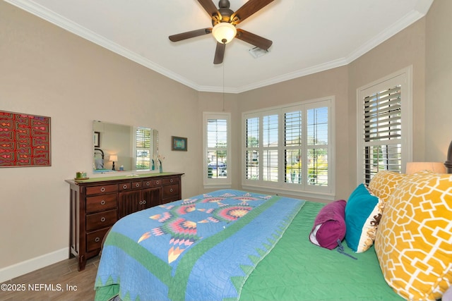 bedroom with visible vents, multiple windows, and ornamental molding