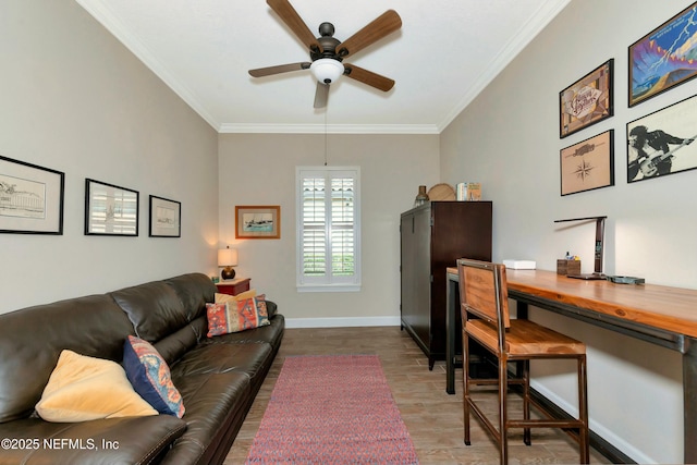 office featuring a ceiling fan, crown molding, wood finished floors, and baseboards