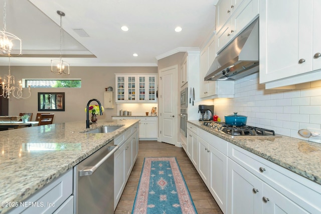 kitchen with visible vents, under cabinet range hood, a sink, white cabinetry, and appliances with stainless steel finishes