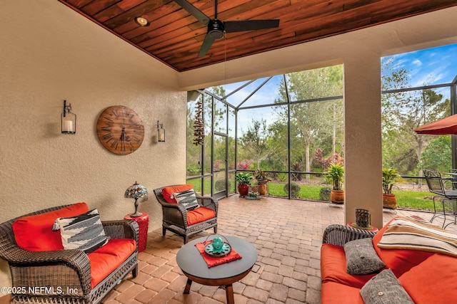 view of patio featuring a ceiling fan, a lanai, and outdoor lounge area