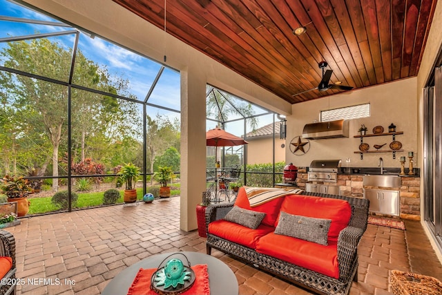 sunroom with wood ceiling and a sink