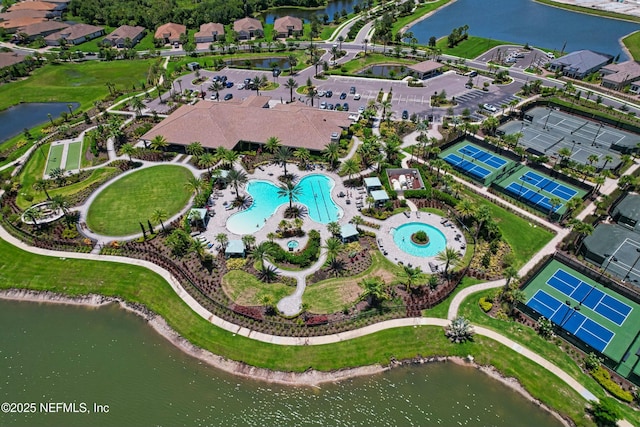 birds eye view of property with a water view