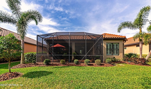 10030 Craftsman Park Way, Palmetto, FL 34221 - back of property featuring a yard, a tile roof, stucco siding, and glass enclosure