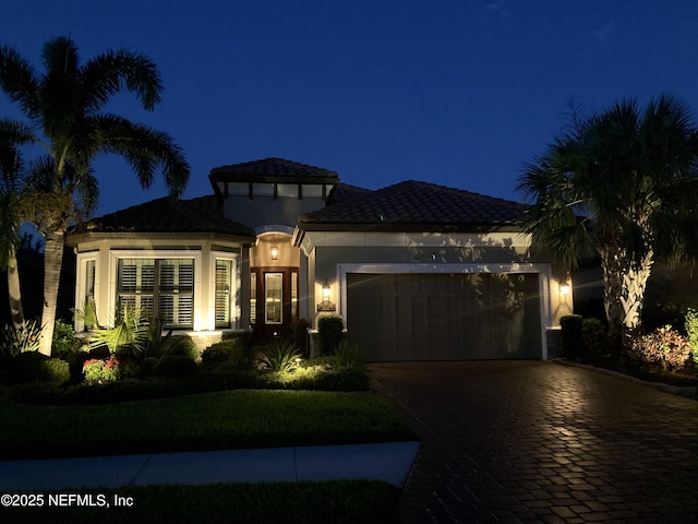 10030 Craftsman Park Way, Palmetto, FL 34221 - mediterranean / spanish-style home featuring an attached garage, decorative driveway, and stucco siding