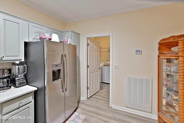 kitchen with visible vents, light wood-style floors, stainless steel fridge with ice dispenser, crown molding, and baseboards