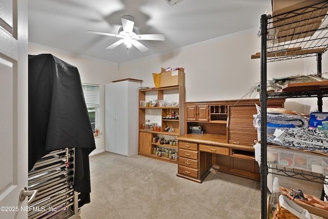 office space with light colored carpet, crown molding, and ceiling fan