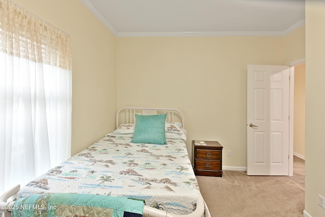 bedroom with crown molding, carpet flooring, and baseboards