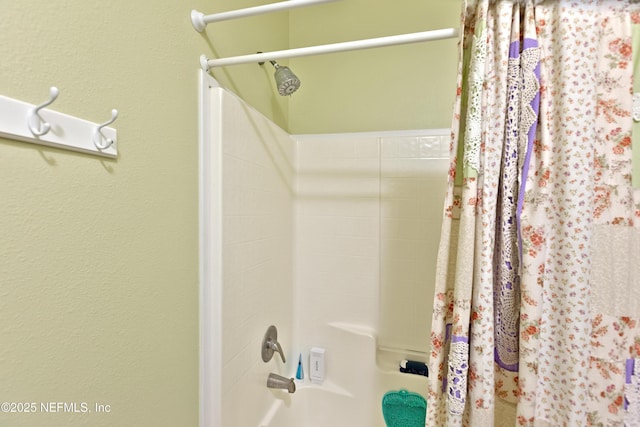 bathroom with shower / bath combination with curtain