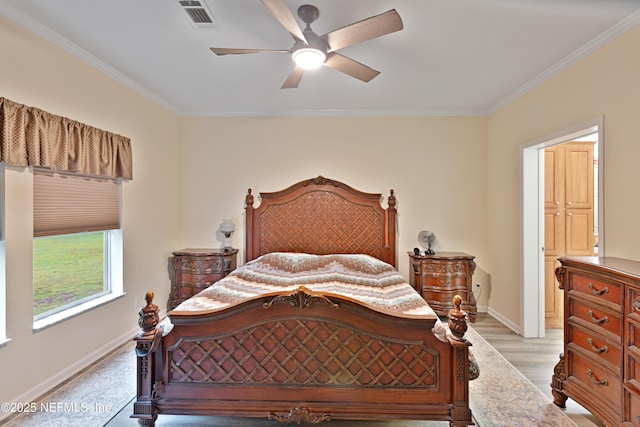 bedroom with visible vents, a ceiling fan, light wood-style floors, crown molding, and baseboards