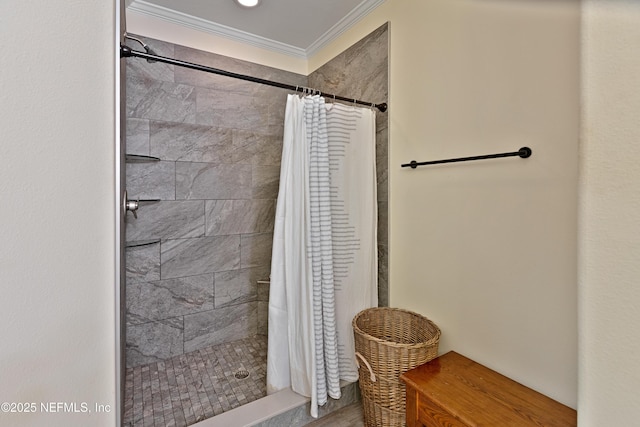 bathroom featuring crown molding and a tile shower