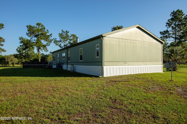 view of side of home featuring a lawn