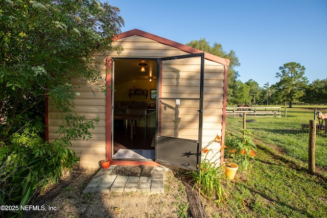 view of shed featuring fence