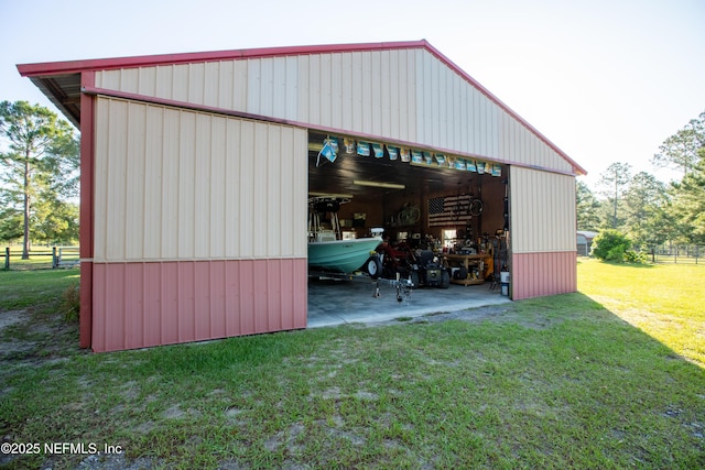 view of pole building featuring a yard and fence