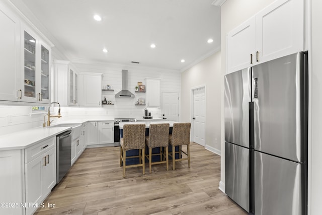 kitchen featuring ornamental molding, a sink, open shelves, stainless steel appliances, and wall chimney range hood