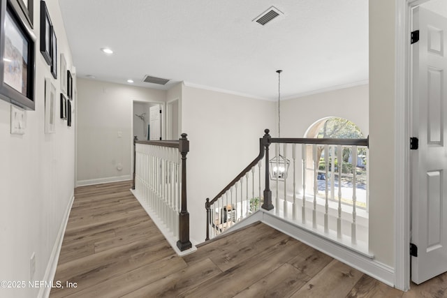 stairs with visible vents, baseboards, recessed lighting, an inviting chandelier, and wood finished floors