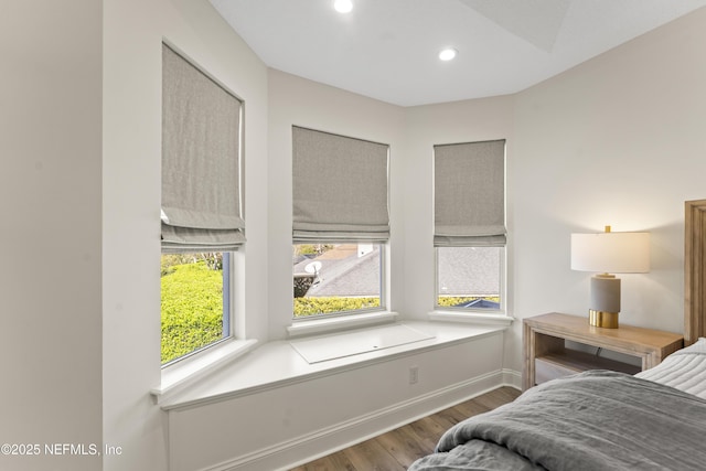 bedroom with recessed lighting, baseboards, multiple windows, and wood finished floors