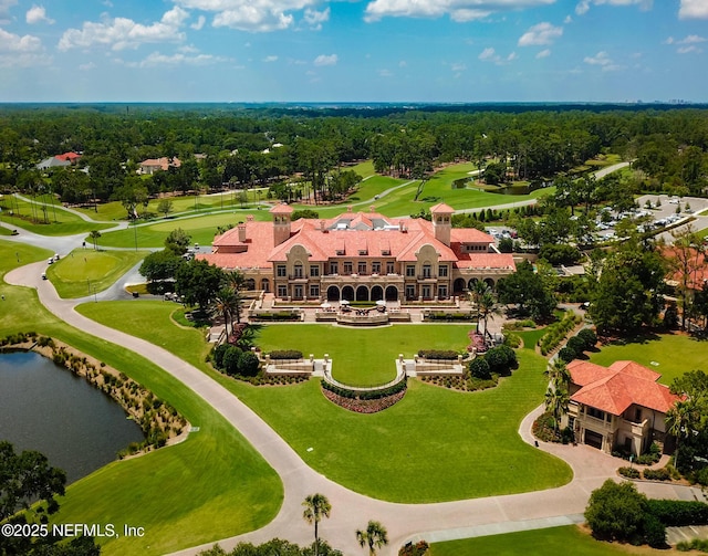 birds eye view of property with golf course view and a water view