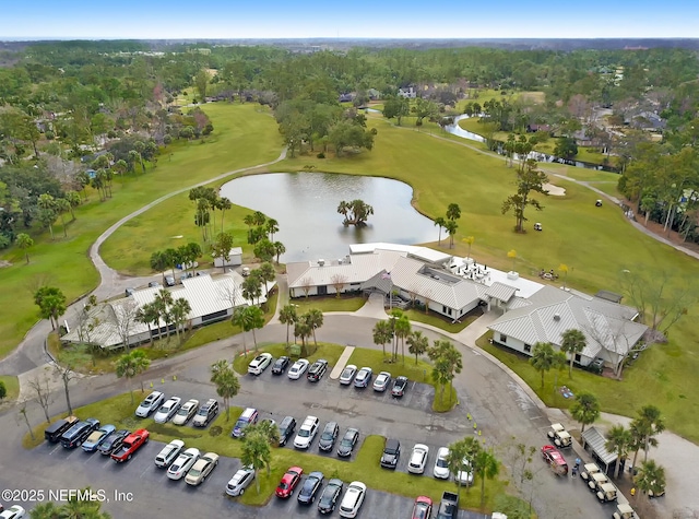 birds eye view of property with a water view and view of golf course