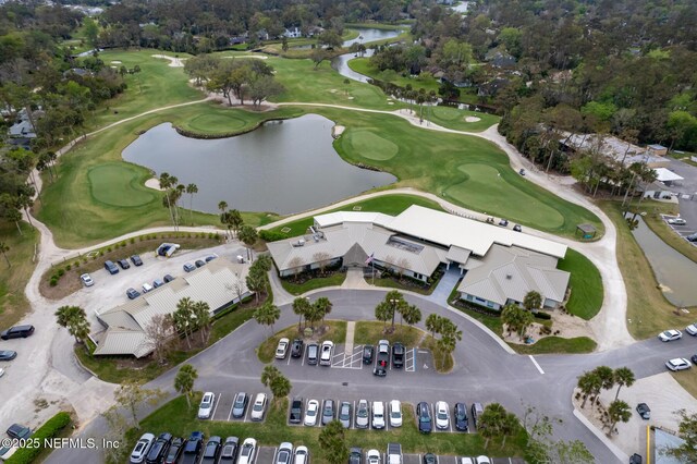 aerial view featuring golf course view and a water view