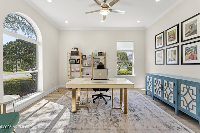 office area with baseboards, wood finished floors, and crown molding