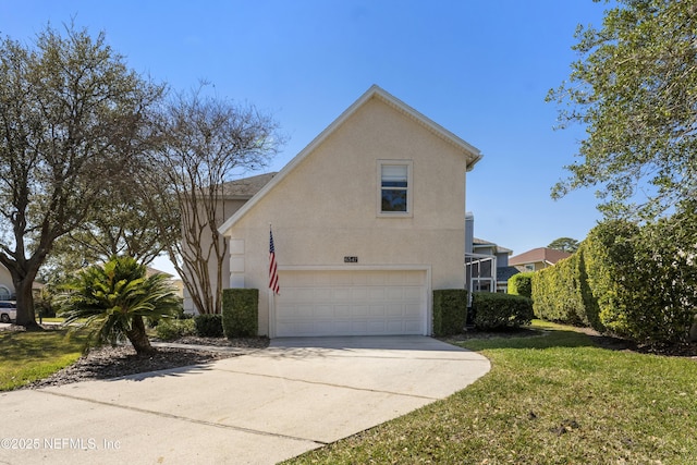 view of side of property with stucco siding, a lawn, an attached garage, and driveway