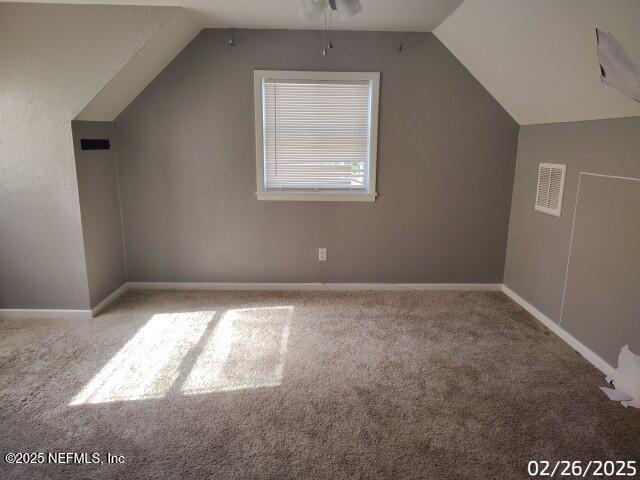 bonus room featuring vaulted ceiling, carpet flooring, baseboards, and visible vents